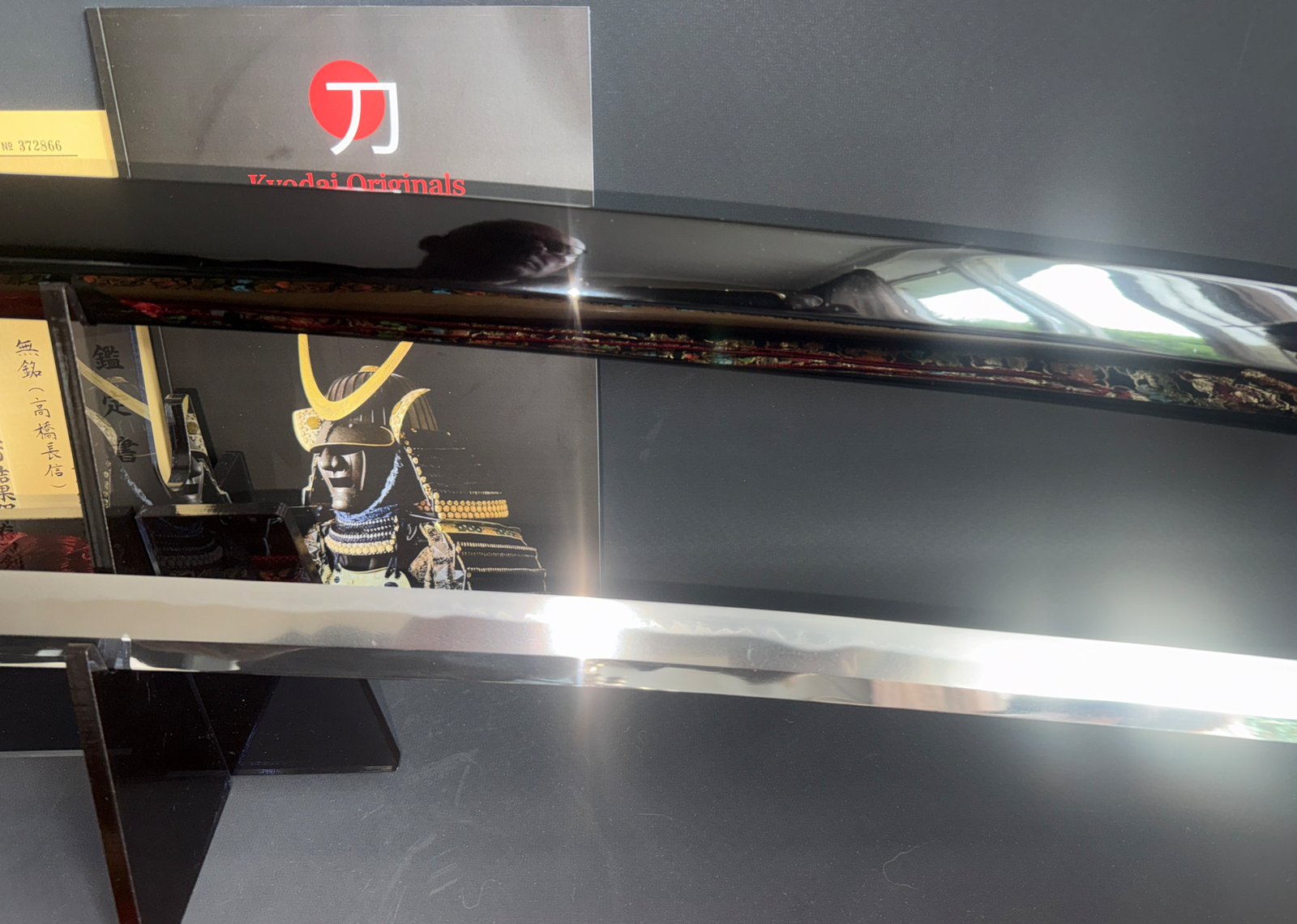 Polished blade of Jinja Hōnō Tachi Naganobu Katana with samurai art background, Kyodai Originals
