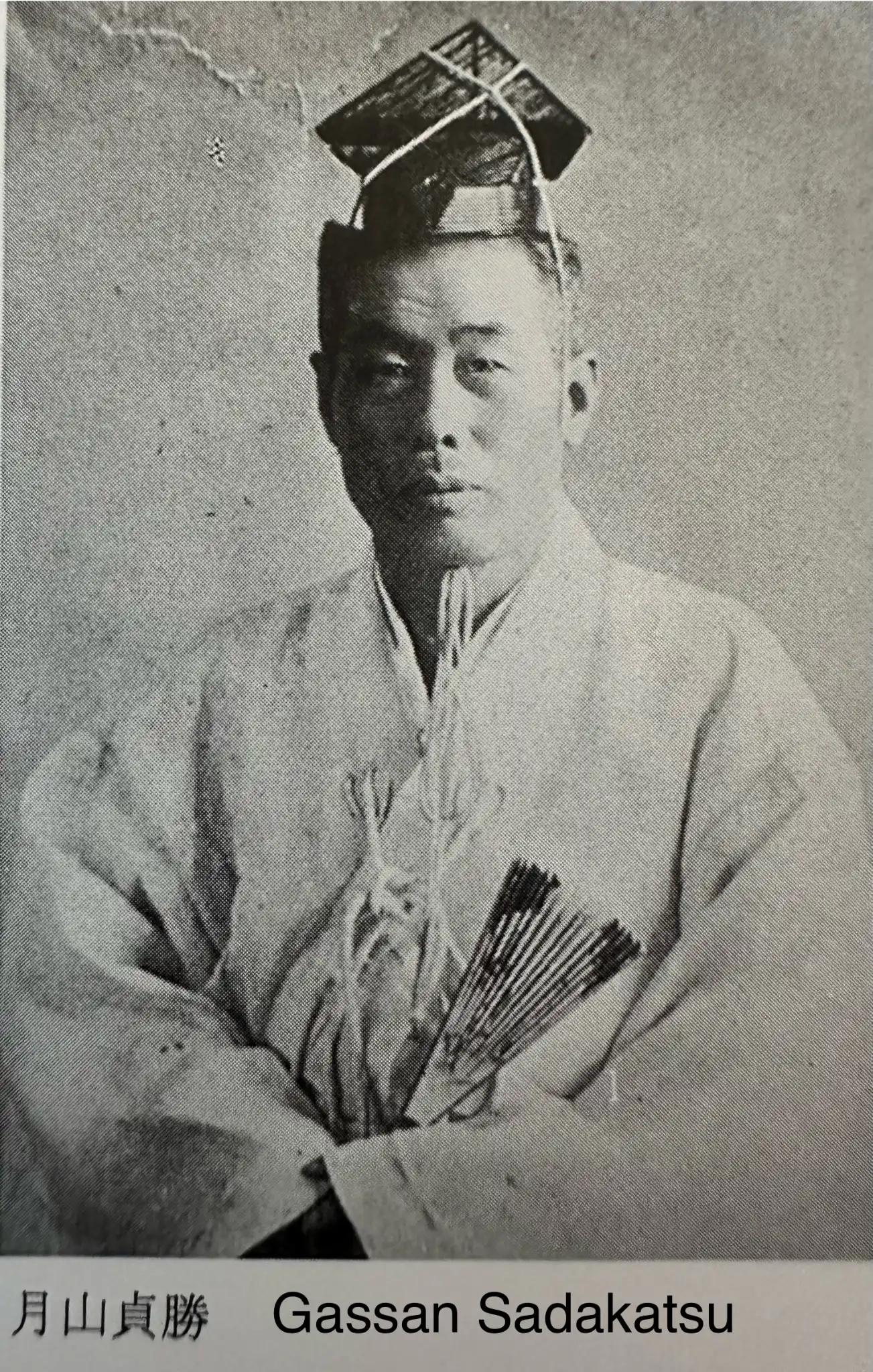 Formal portrait of Gassan Sadakatsu in traditional attire, a master smith of the Tanto category