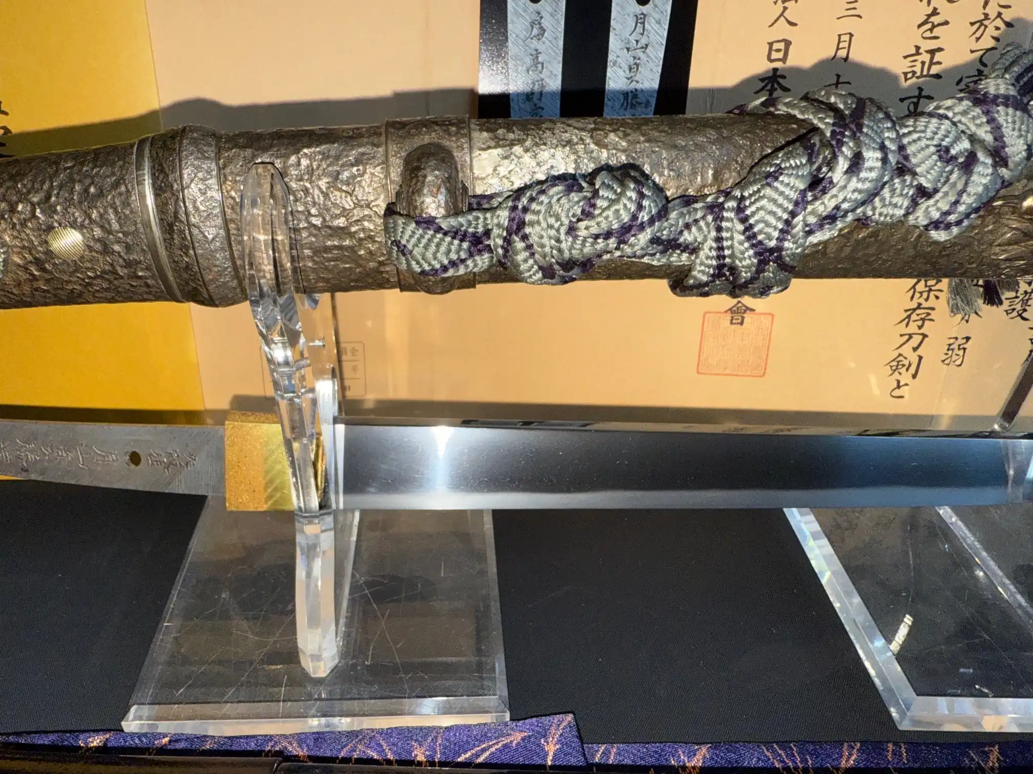 Tanto Gassan Sadakatsu, the exquisite Japanese short sword, displayed with its textured sheath and braided cord