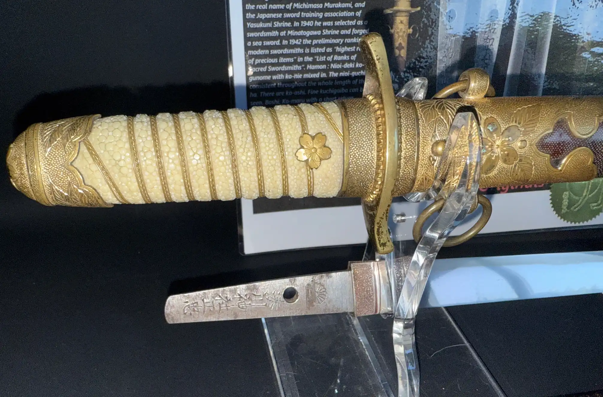 Close up of a Minatogawa Tanto Masatada, showing detailed gold-wrapped koshirae and part of the blade.