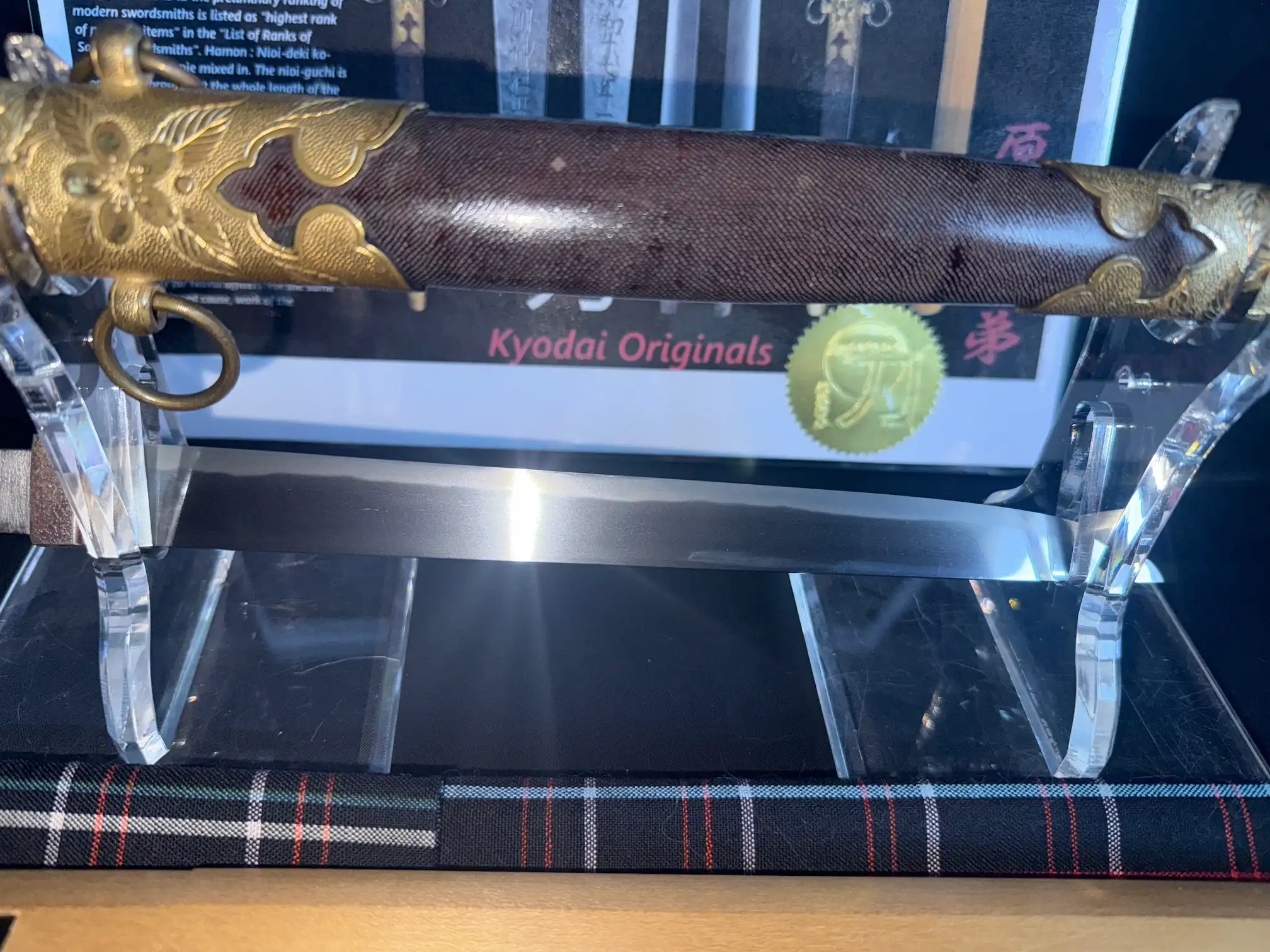 Close up of Minatogawa Tanto Masatada, its blade and detailed golden koshirae, a Japanese tanto.