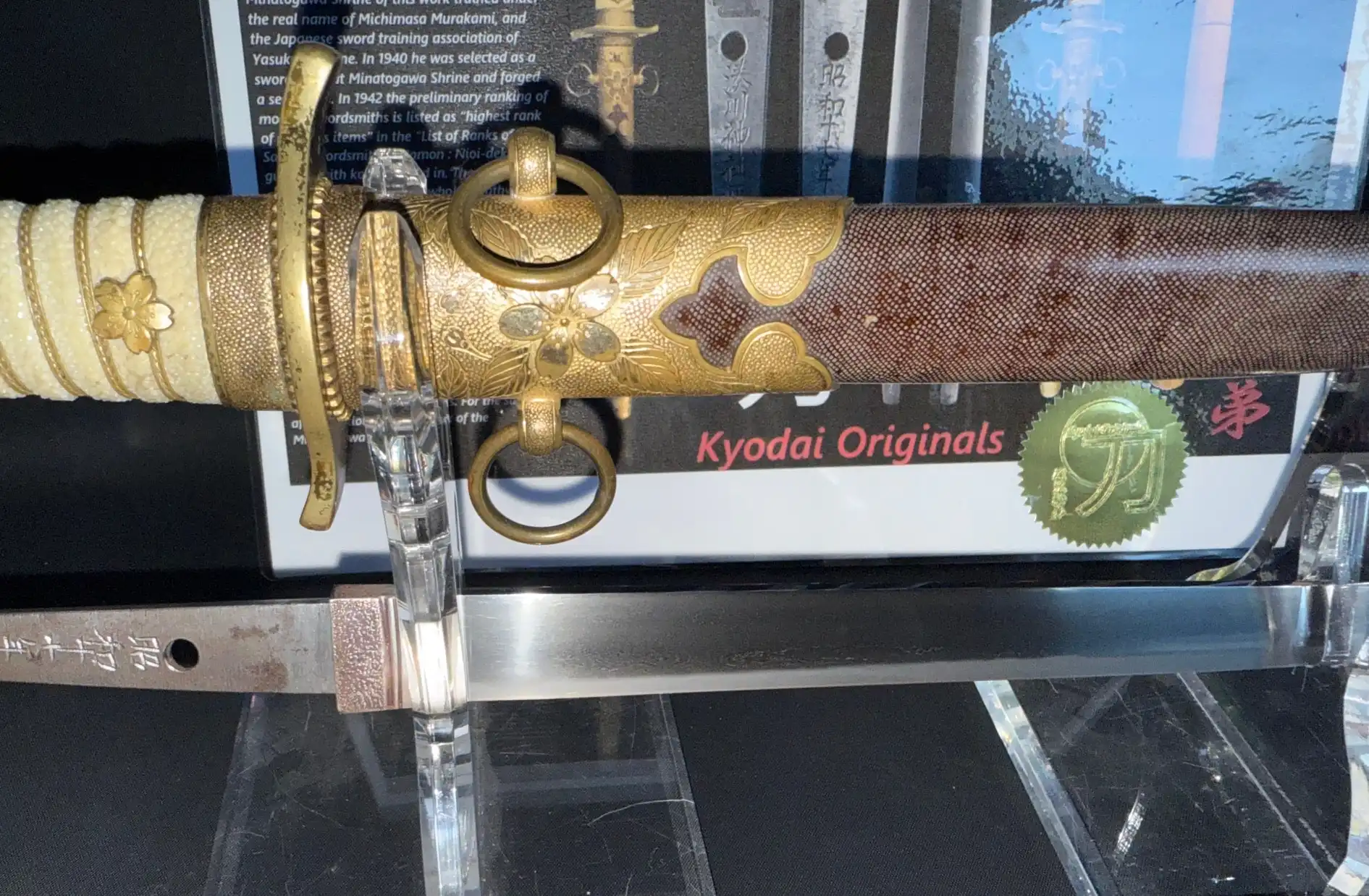 Minatogawa Tanto Masatada, a Japanese tanto with a decorative golden scabbard and detailed blade.