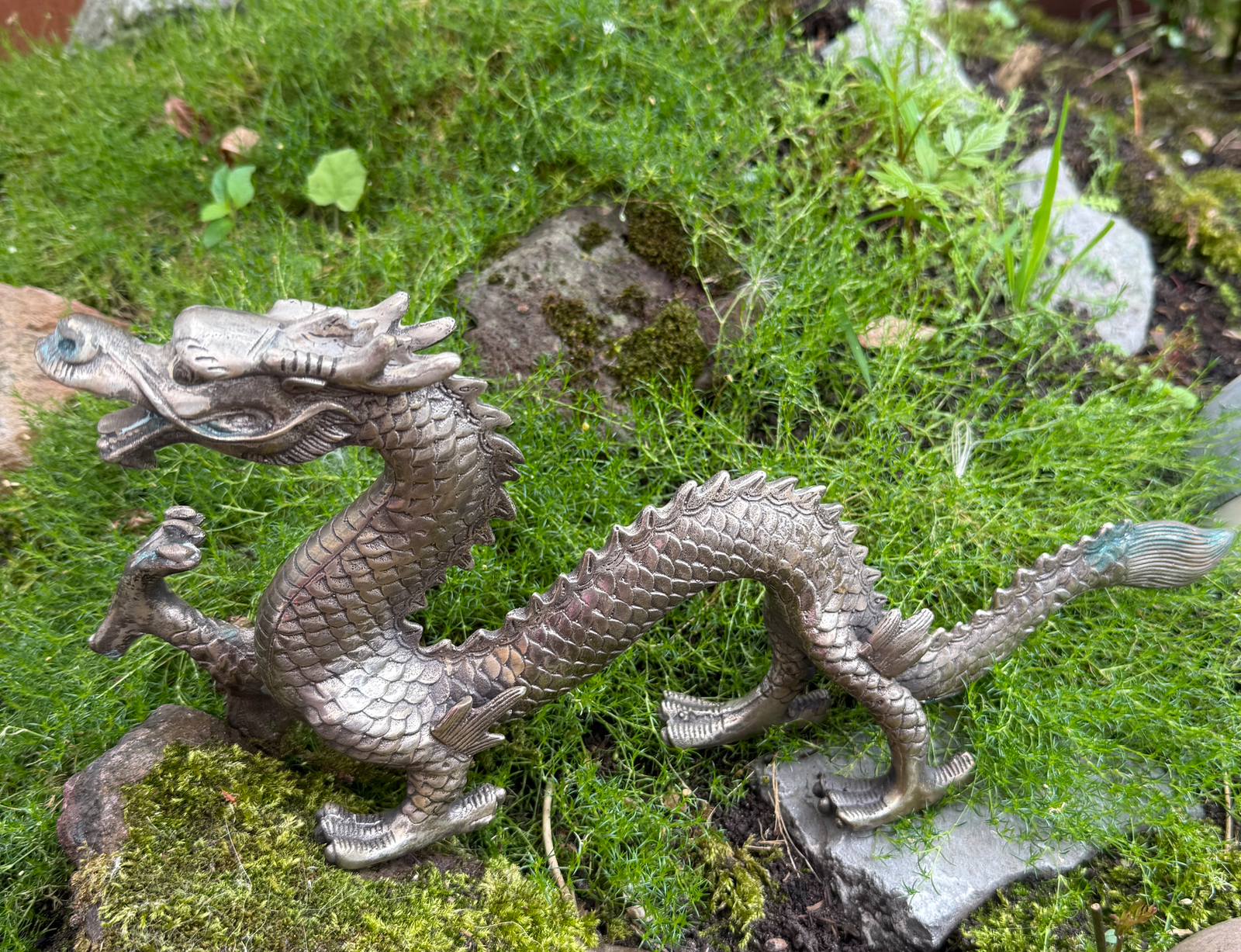 Silvered Japanese dragon sculpture from Meiji Period on mossy ground, a rare katana related antique.