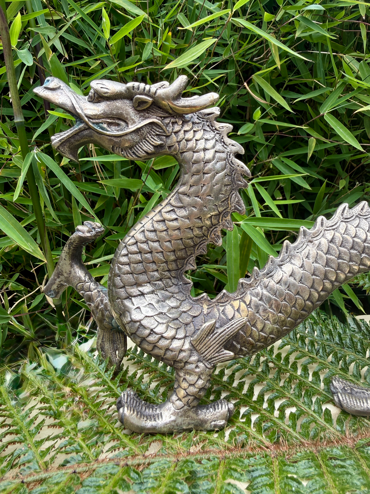 Silvered Japanese dragon sculpture in Meiji Period style, head and scales details visible, for katana collectors