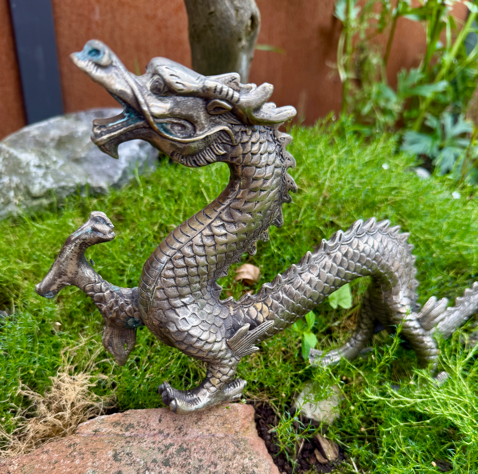 Silvered japanese dragon sculpture meiji 33cm in coiled pose on moss, a unique katana accessory.