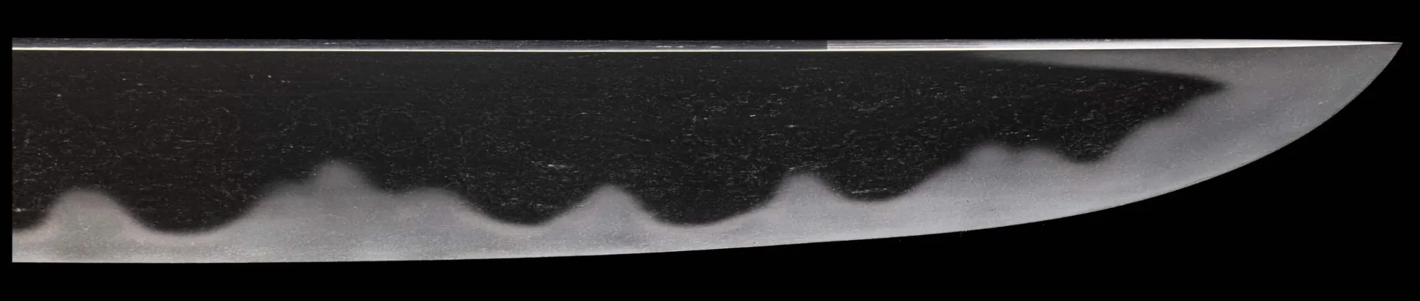 Gleaming Tantō Muramasa Demon Steel blade with hamon pattern, close-up of tip and edge.