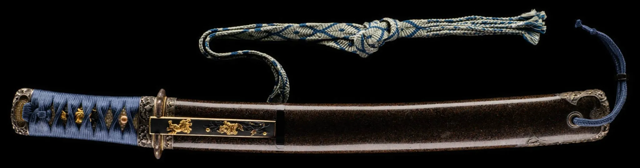 Tantō Muramasa Demon Steel with blue tsuka-ito and textured dark saya, with a colorful patterned sageo