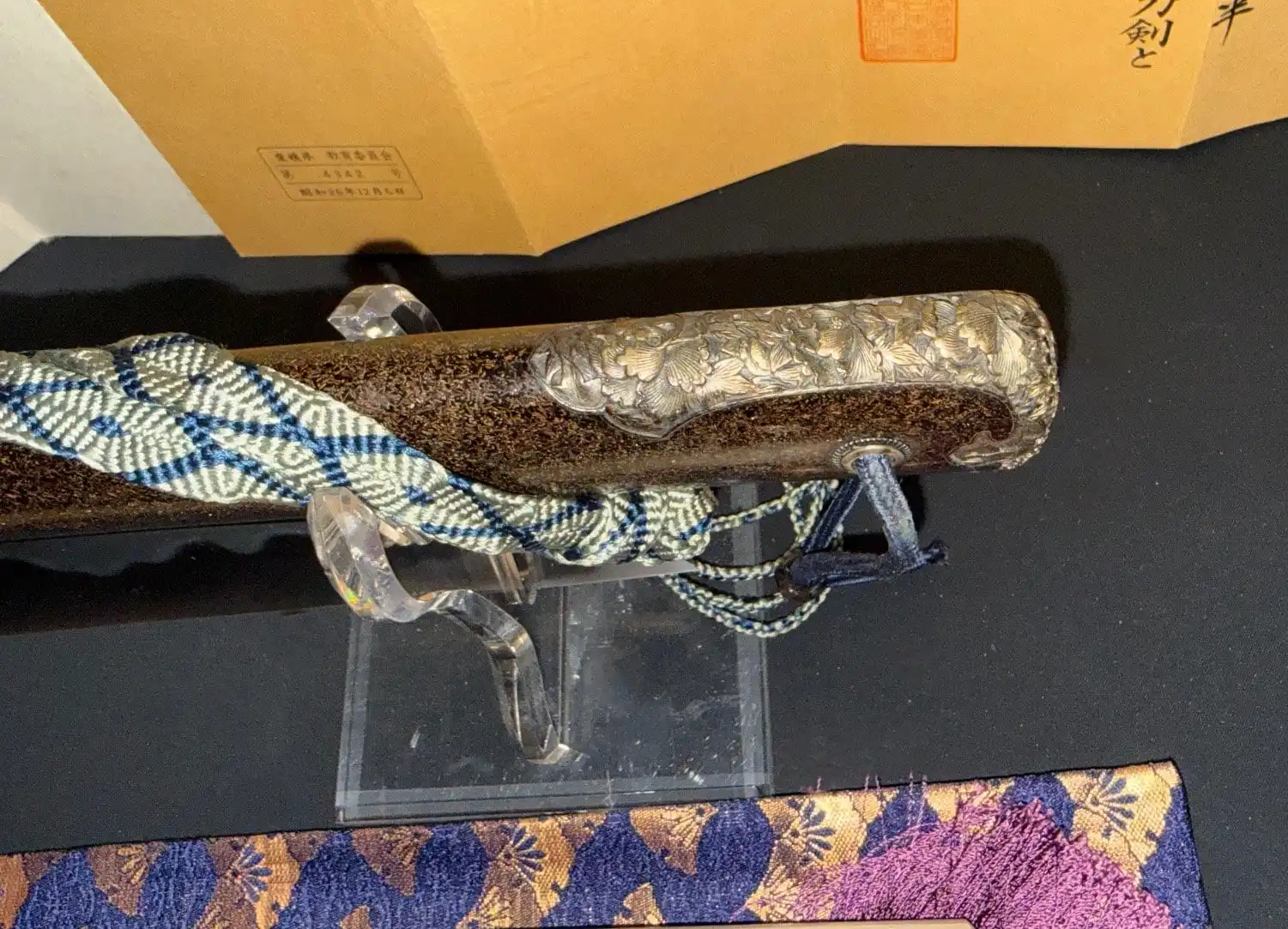 Tantō Muramasa Demon Steel with ornate silver tsuka and blue/white cord, close up view, a Japanese dagger