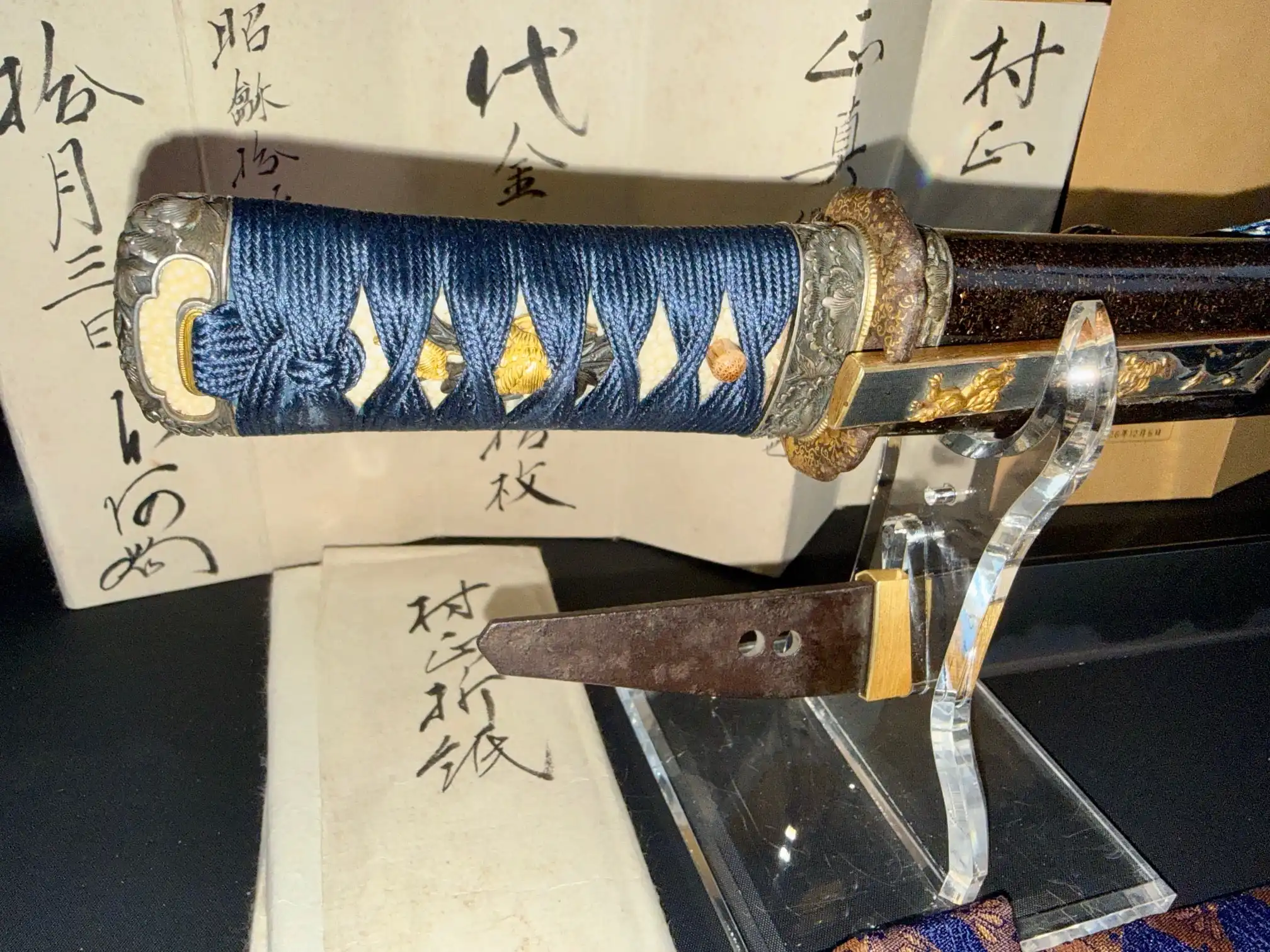 Tantō Muramasa Demon Steel handle, blue ito, and tang against calligraphy, Late Muromachi period