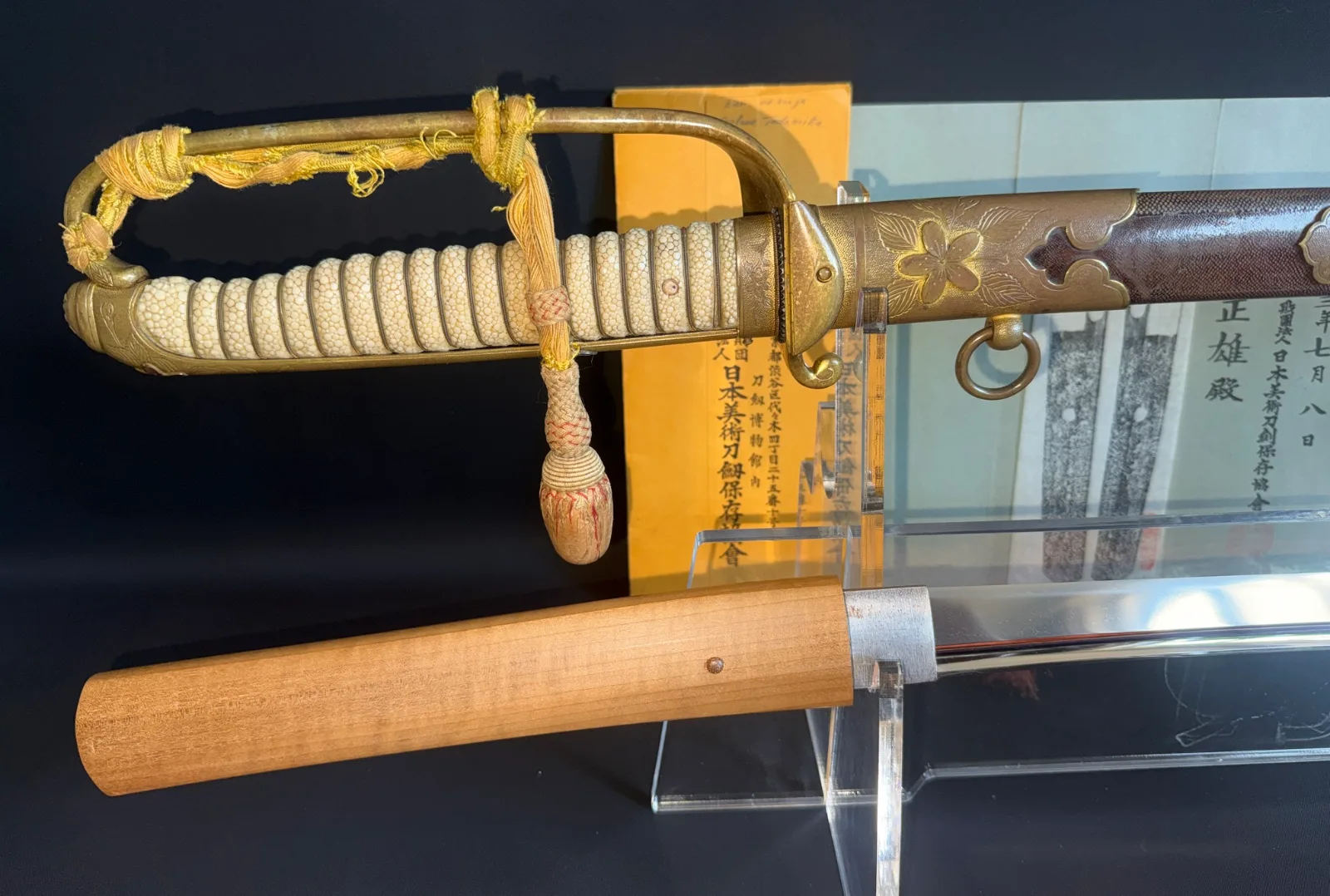 Naruse Family Heirloom katana: Close-up of the Guntō-mounted handle and part of the blade, with documentation visible.