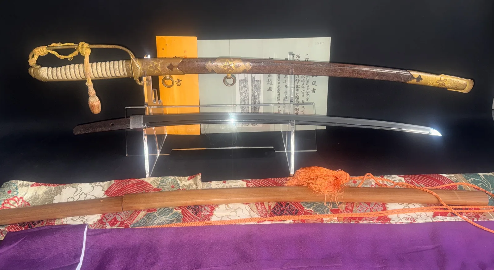 Naruse Family Heirloom Bizen Osafune Tadamitsu Katana in Kyū Guntō koshirae, blade separated from scabbard on stand