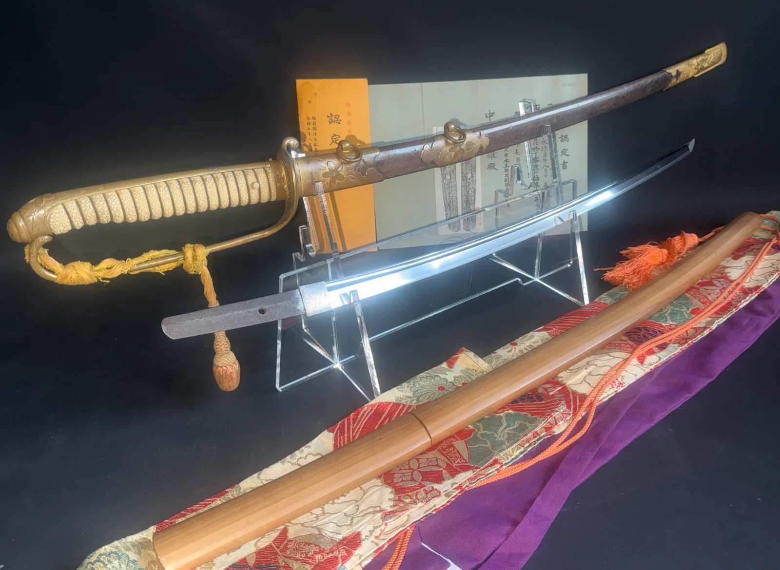 Naruse Family Heirloom Bizen Osafune Tadamitsu katana in Kyū Guntō mounts, partially unsheathed, on stand
