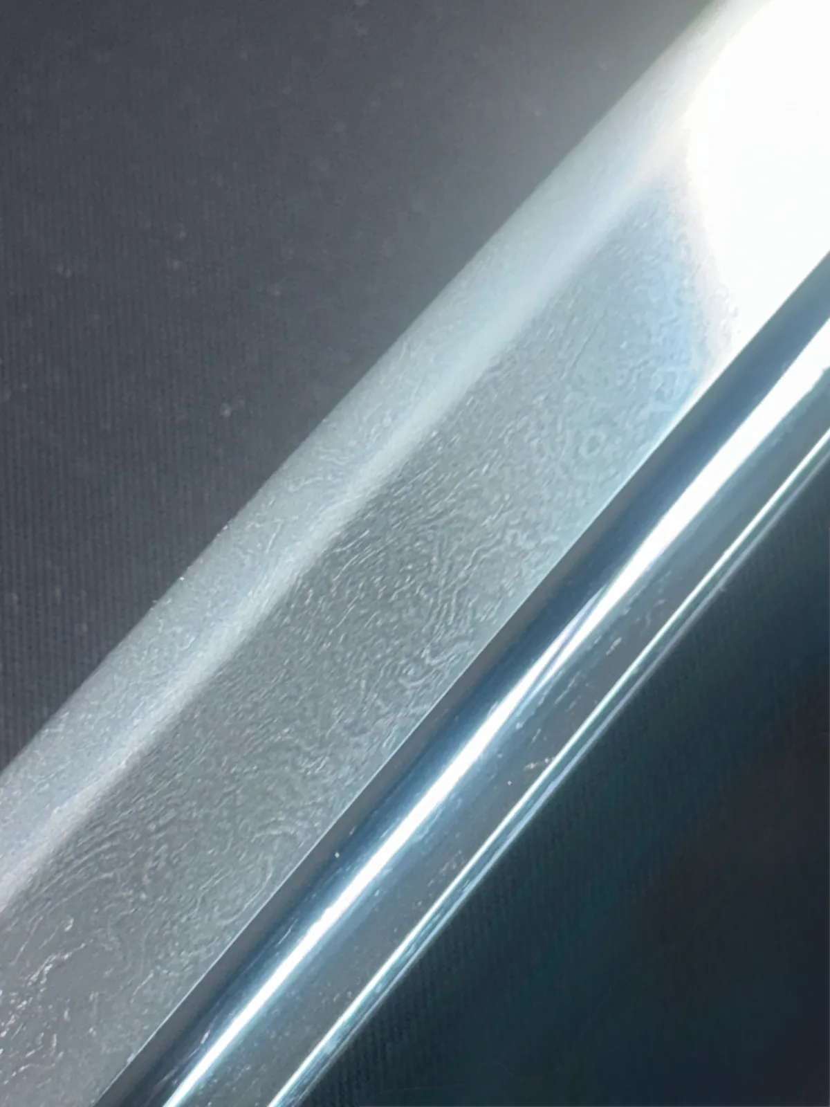 Close-up of Naruse Family Heirloom Bizen Osafune Tadamitsu Katana blade showing hamon and jihada patterns