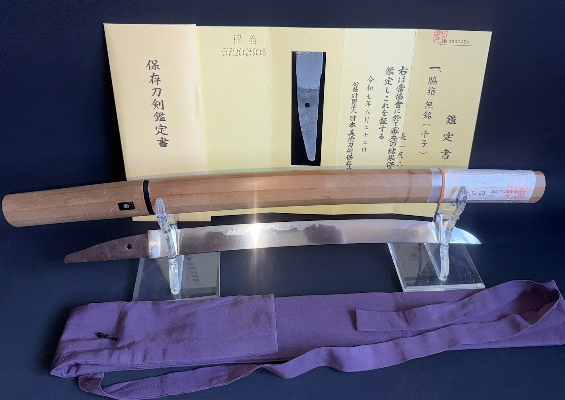 Mumei Wakizashi Sengo Muramasa, with blade, scabbard, and certification papers, top-down view.