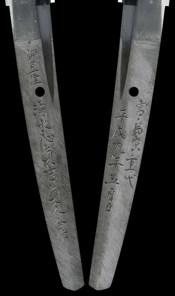 Close-up of the engraved tangs of the Tachi Katana Sadayoshi/Sadahito, showing signatures and date, ancient Japanese katana.