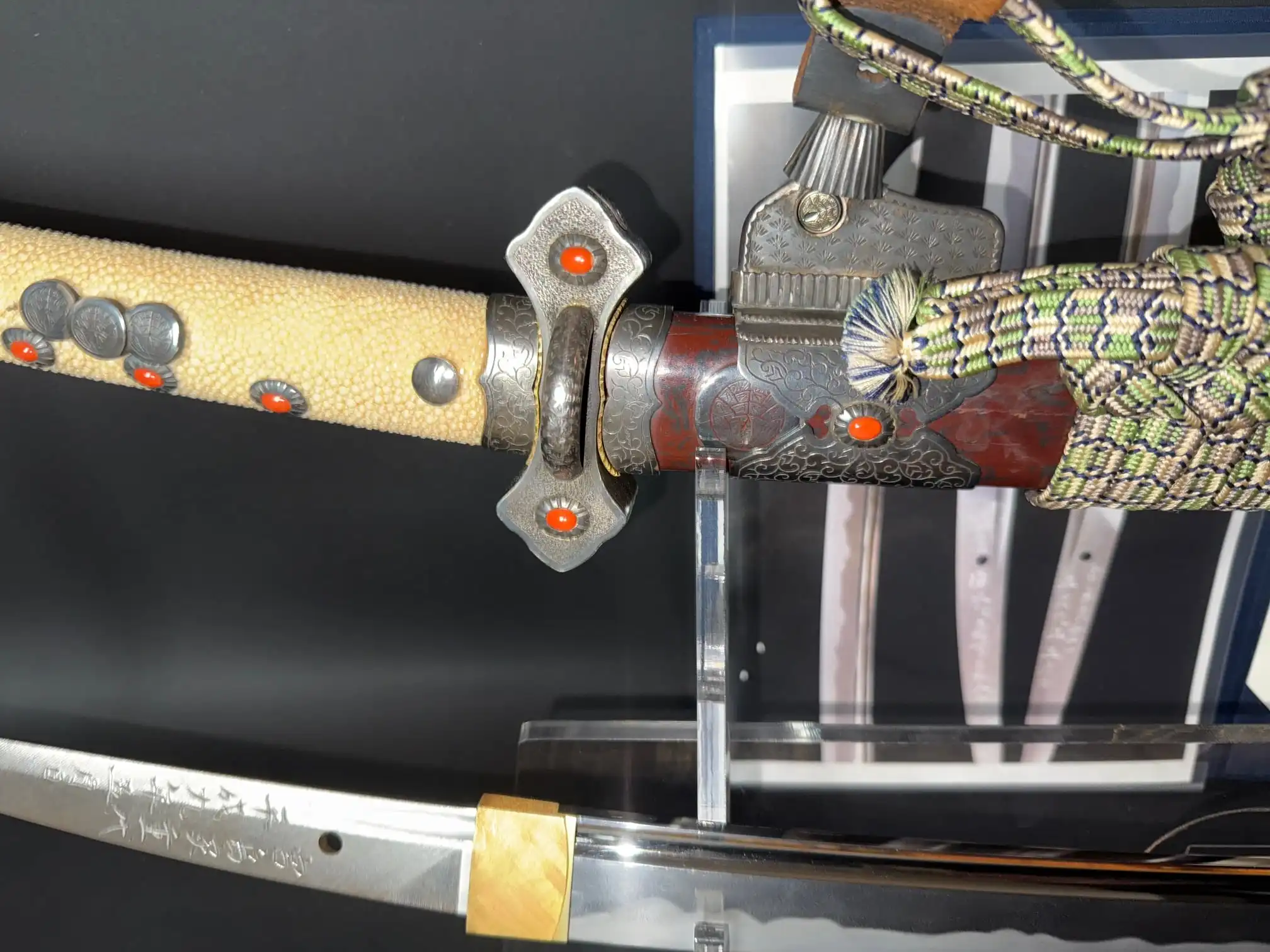 Close-up, top-down of a Tachi Katana Sadayoshi/Sadahito, showing a detailed handle and inscribed blade