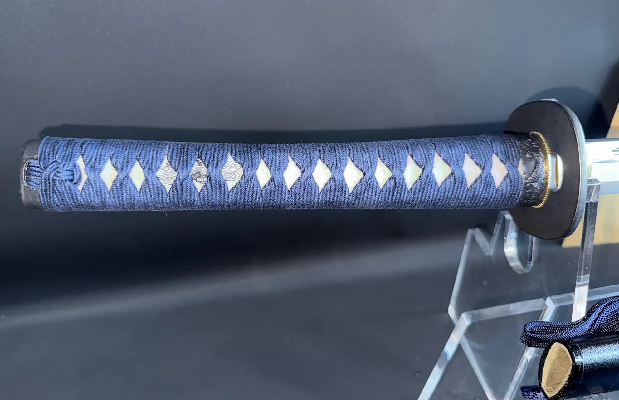 Close up of a new IAITO MINOSAKA TOKUSEI Japanese Iaido sword handle wrapped in blue with white diamonds.