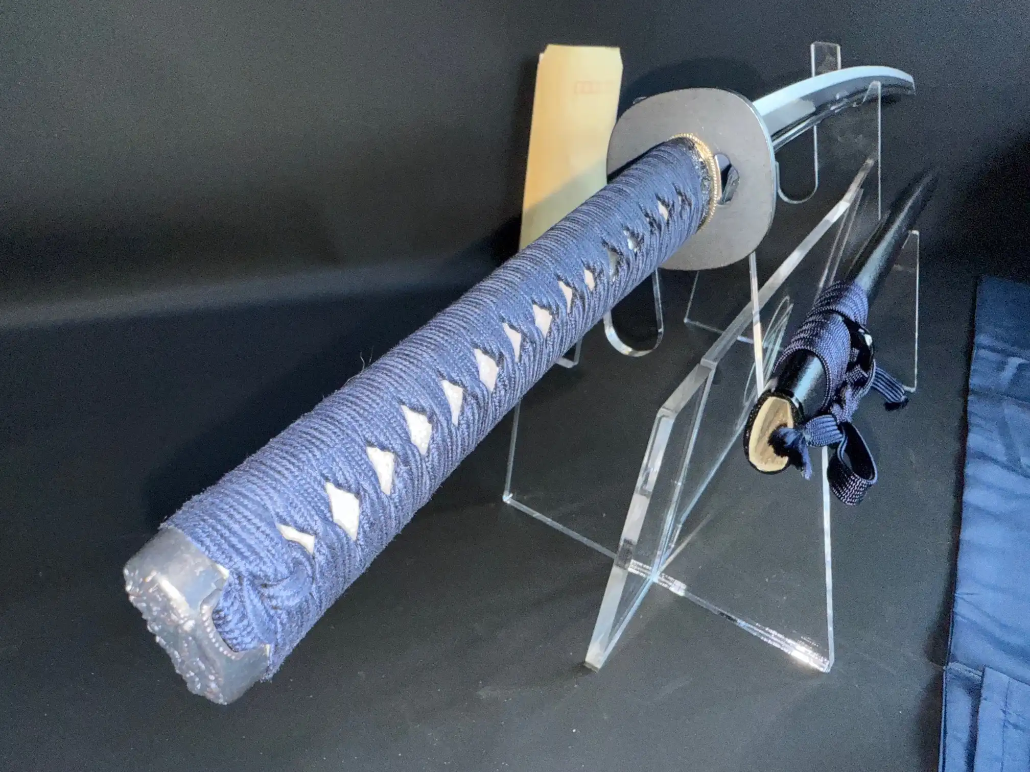 IAITO MINOSAKA TOKUSEI Japanese Iaido sword: blue tsuka wrap, partial view on display stand