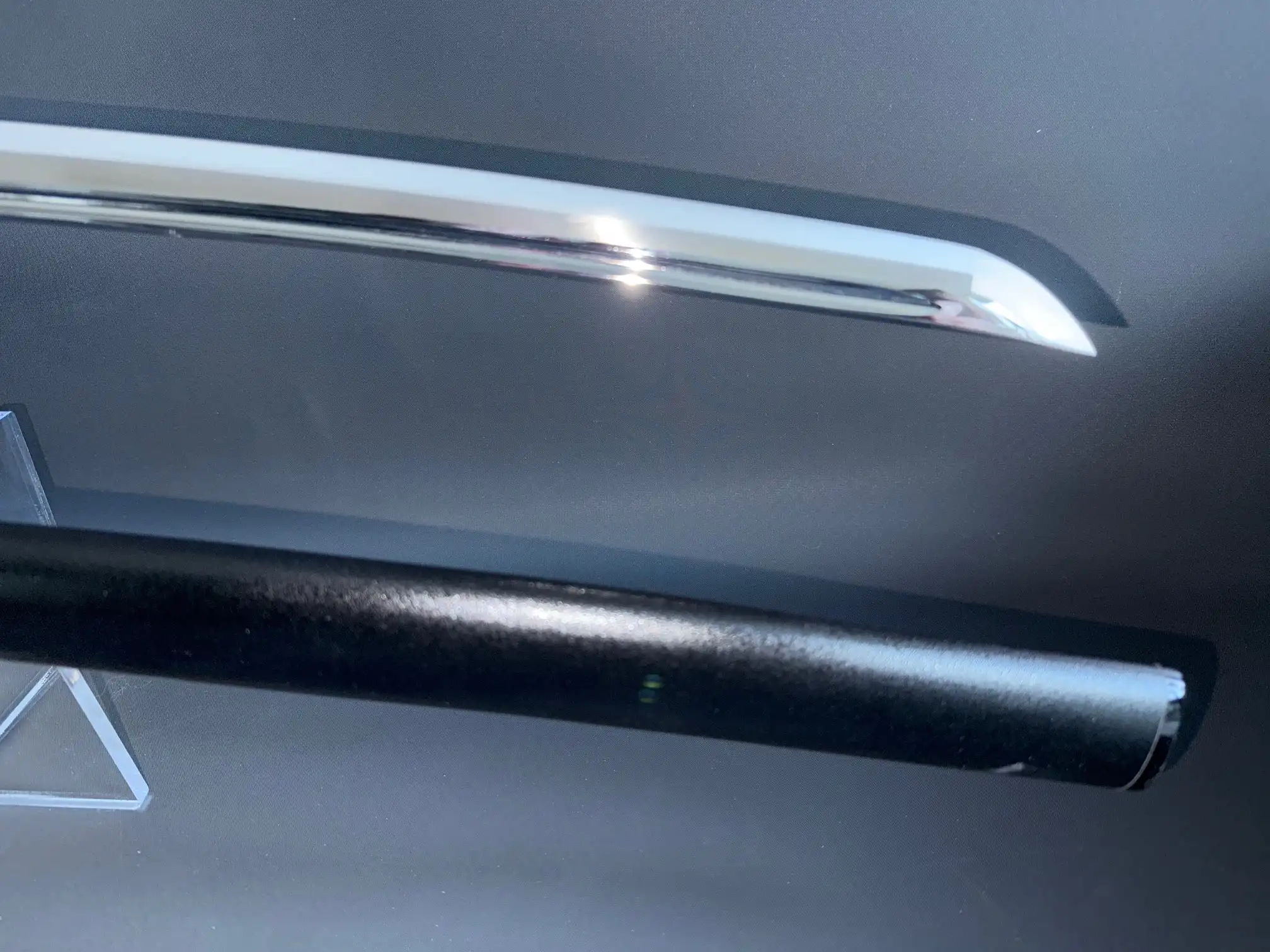 Reflective blade and black scabbard of IAITO MINOSAKA TOKUSEI Japanese Iaido sword from above.